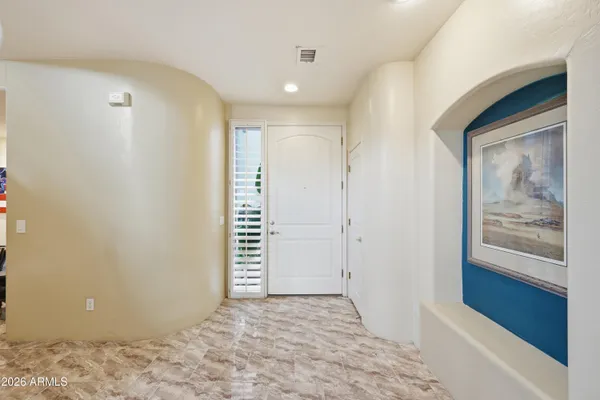 a living room with furniture a flat screen tv and a large window
