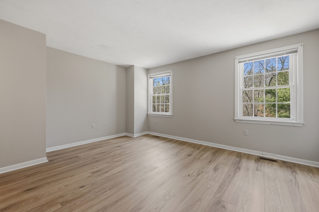 13 Pullard Road, Unit 31 Grafton, MA 01519 - Photo 14 of 34 a view of an empty room with wooden floor and a window