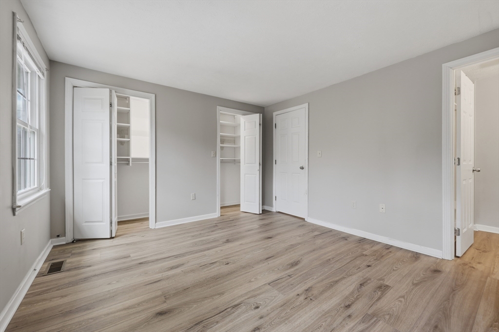 13 Pullard Road, Unit 31 Grafton, MA 01519 - Photo 16 of 34 a view of an empty room with wooden floor and window