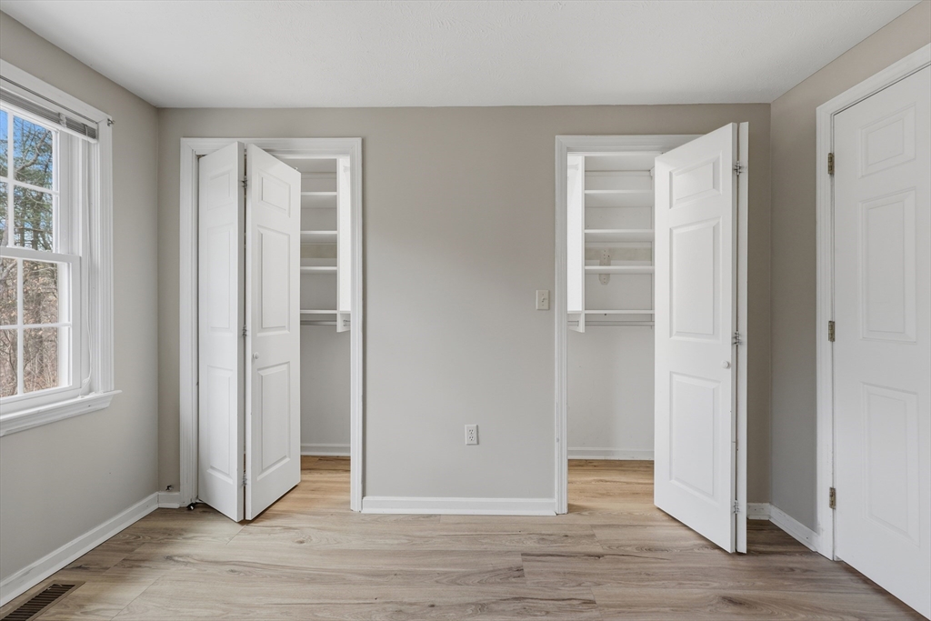 13 Pullard Road, Unit 31 Grafton, MA 01519 - Photo 18 of 34 an empty room with wooden floor closet and windows