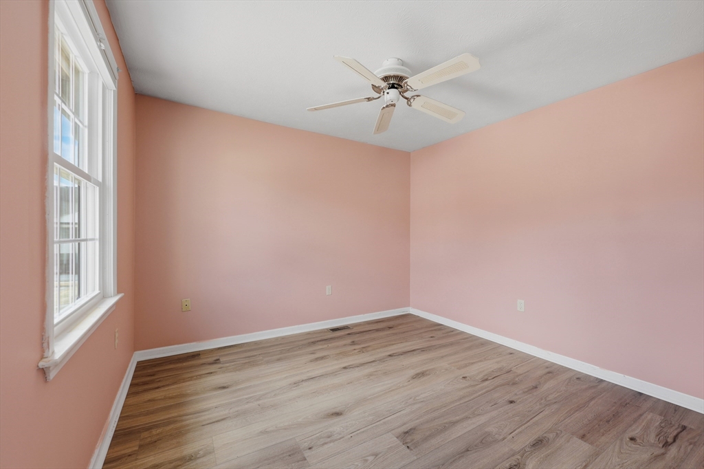13 Pullard Road, Unit 31 Grafton, MA 01519 - Photo 22 of 34 a view of an empty room with wooden floor and a window