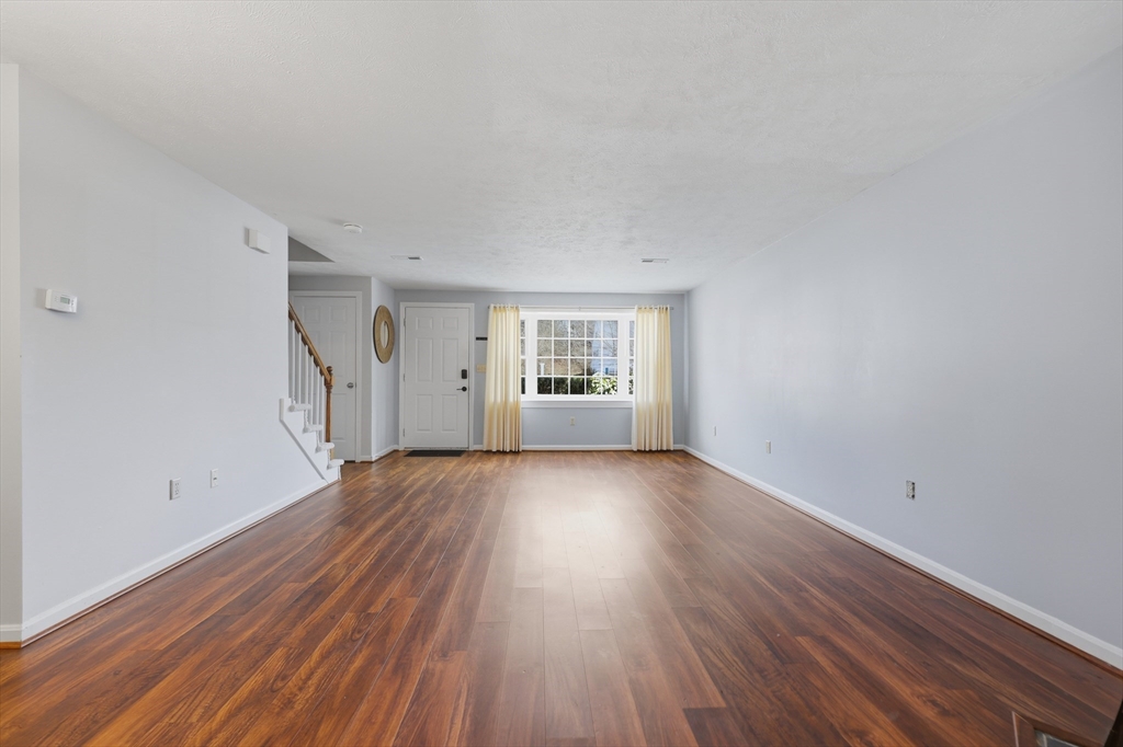 13 Pullard Road, Unit 31 Grafton, MA 01519 - Photo 4 of 34 a view of an empty room with wooden floor and a window