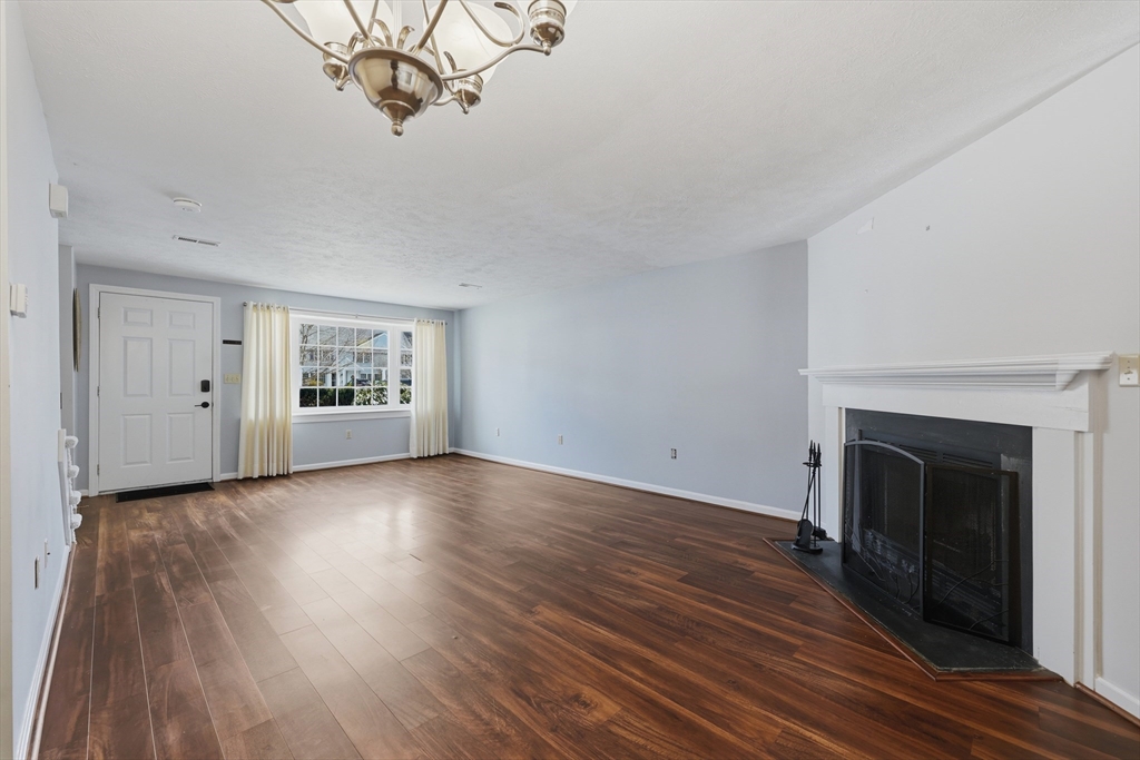 13 Pullard Road, Unit 31 Grafton, MA 01519 - Photo 8 of 34 a view of a livingroom with wooden floor and a fireplace