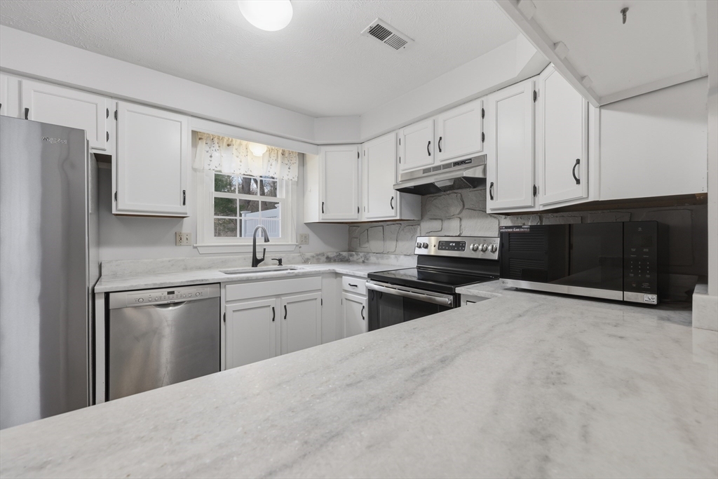 13 Pullard Road, Unit 31 Grafton, MA 01519 - Photo 10 of 34 a kitchen with stainless steel appliances granite countertop a refrigerator stove a sink and dishwasher