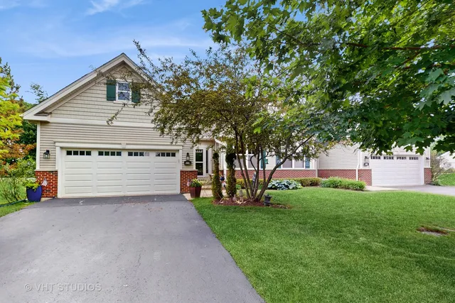 a front view of house with yard and green space