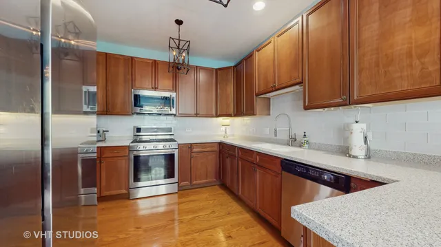 a bathroom with a sink a toilet a mirror and shower