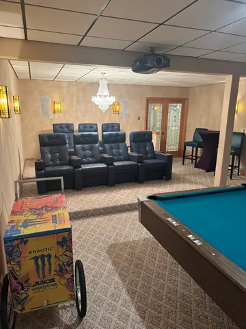 a view of a swimming pool with lawn chairs under an umbrella