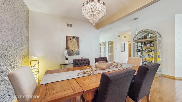 a kitchen with stainless steel appliances granite countertop a sink a stove and a refrigerator