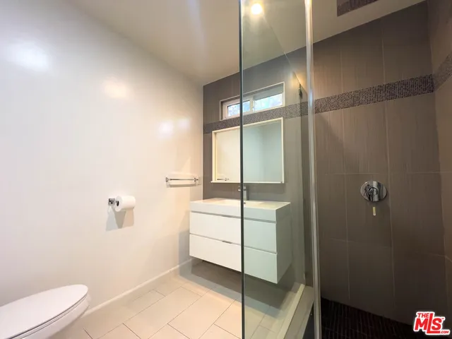 a bathroom with a shower and a toilet