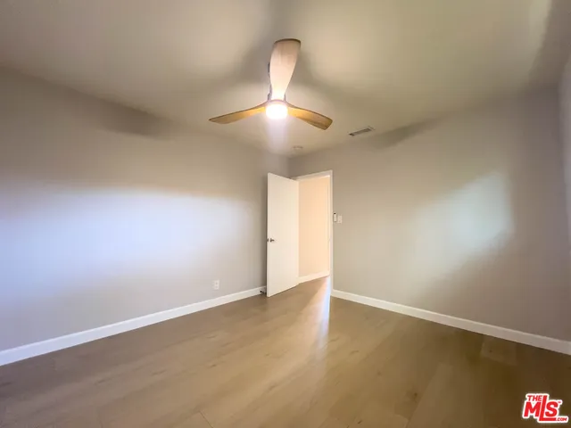 a view of an empty room and wooden floor