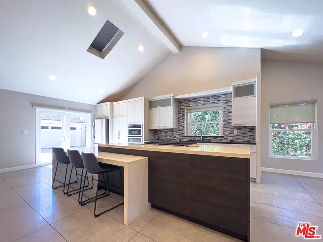 a kitchen with a stove and a refrigerator