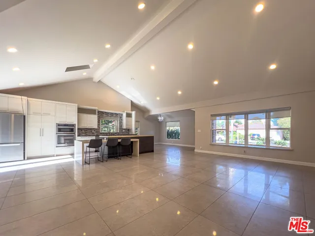a large hall with stainless steel appliances a large window