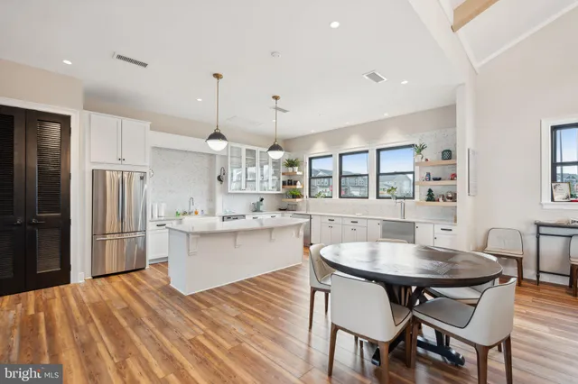 a kitchen with stainless steel appliances granite countertop a sink stove and wooden floor