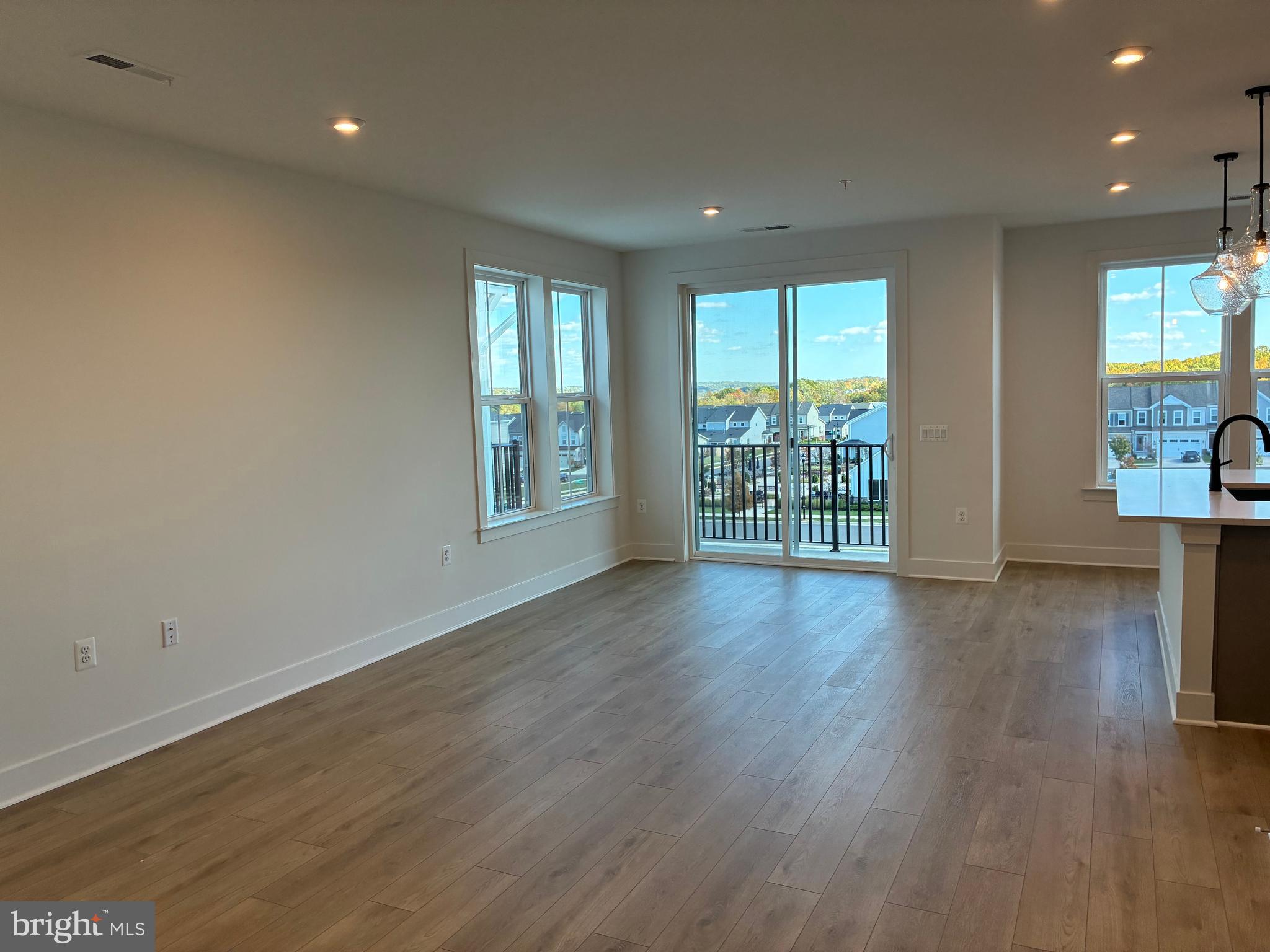 248 Violet Way, Unit 2 Stafford, VA 22554 - Photo 5 of 41 a view of an empty room with wooden floor and a window