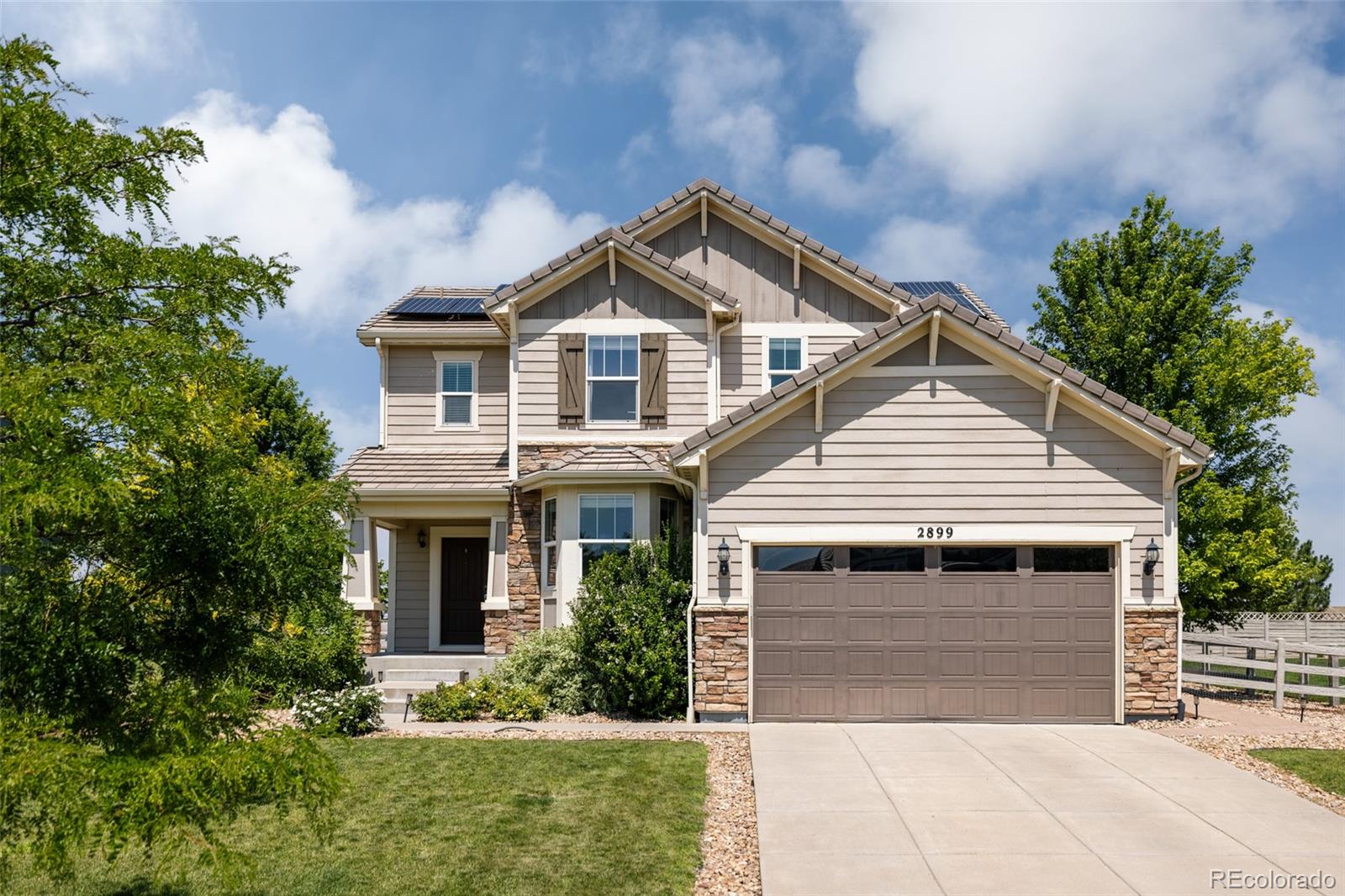 2899 Trinity Loop Broomfield, CO 80023 - Photo 1 of 33 a front view of a house with a yard and garage