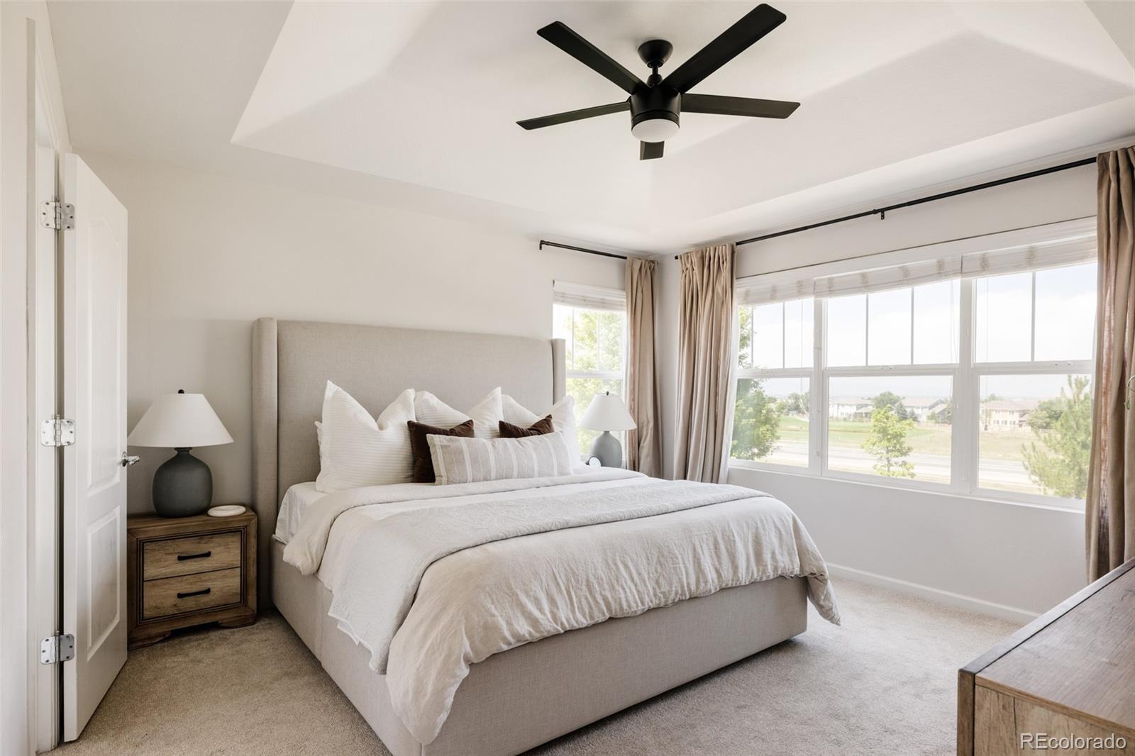 2899 Trinity Loop Broomfield, CO 80023 - Photo 13 of 33 a bedroom with bed and a large window