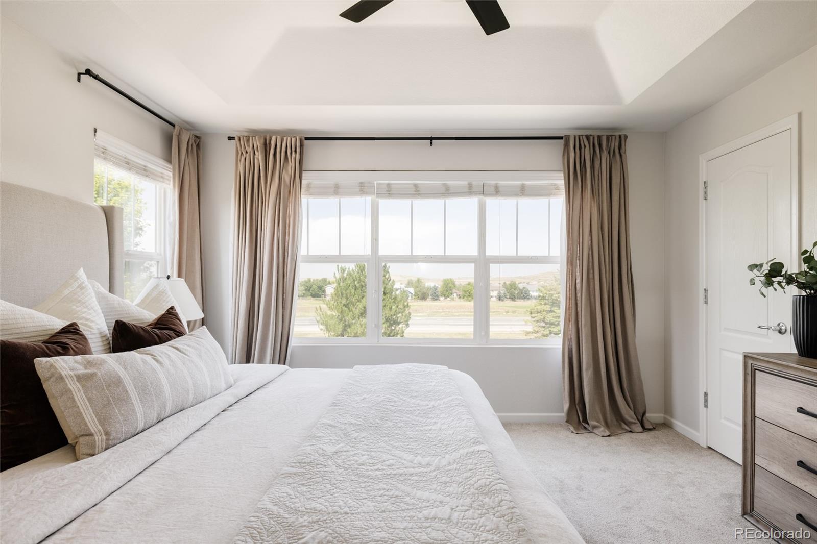 2899 Trinity Loop Broomfield, CO 80023 - Photo 14 of 33 a bedroom with a bed and a large window