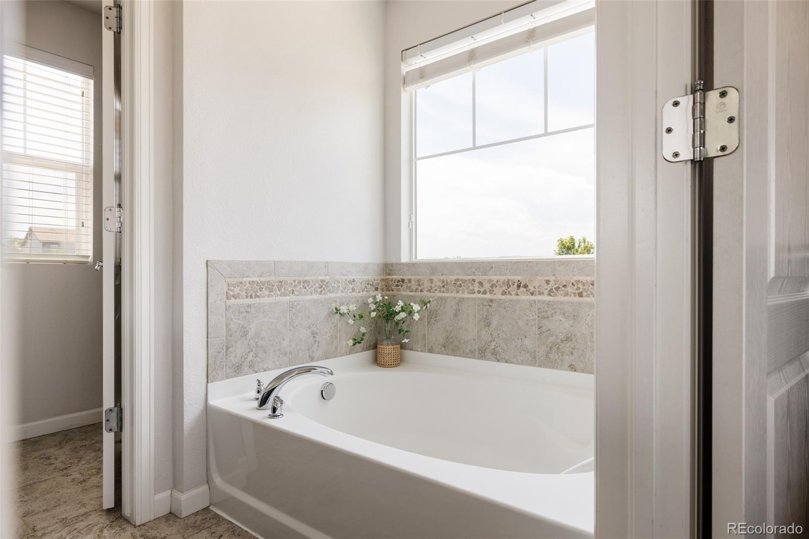 2899 Trinity Loop Broomfield, CO 80023 - Photo 18 of 33 a white bath tub sitting next to a window