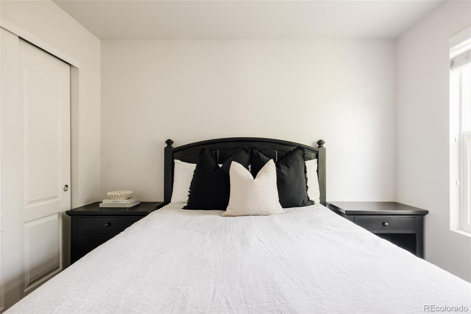 2899 Trinity Loop Broomfield, CO 80023 - Photo 21 of 33 a bedroom with a bed and a night stand