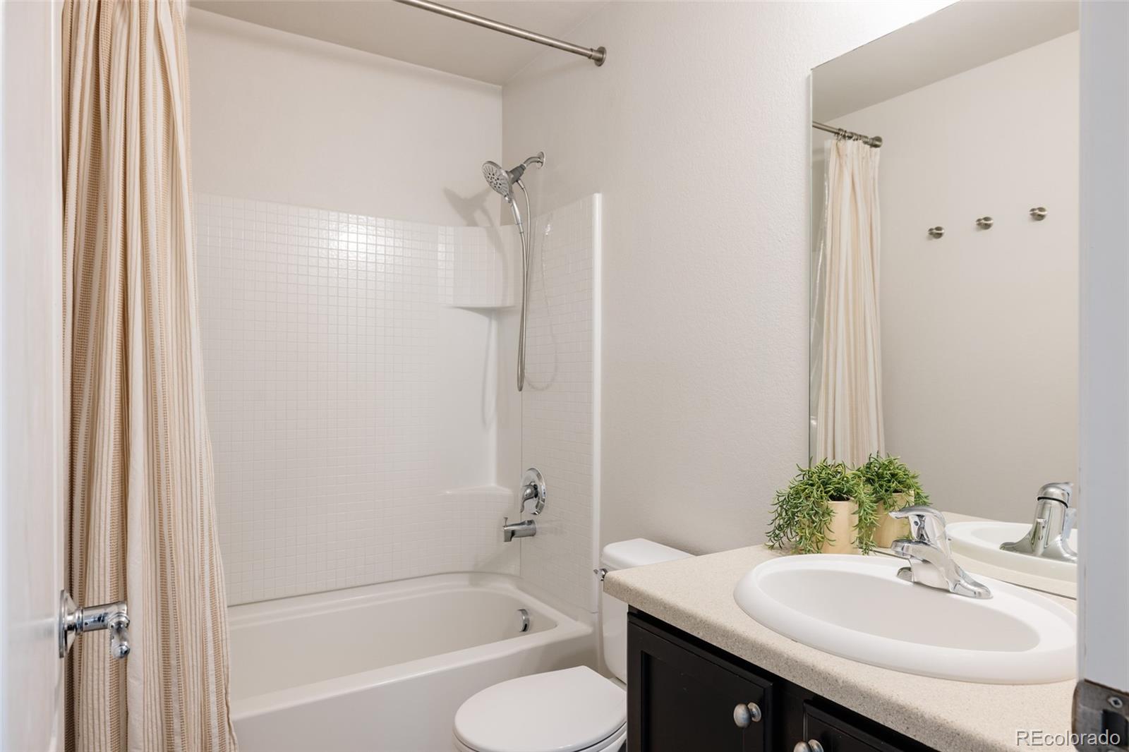 2899 Trinity Loop Broomfield, CO 80023 - Photo 23 of 33 a bathroom with a sink and a mirror