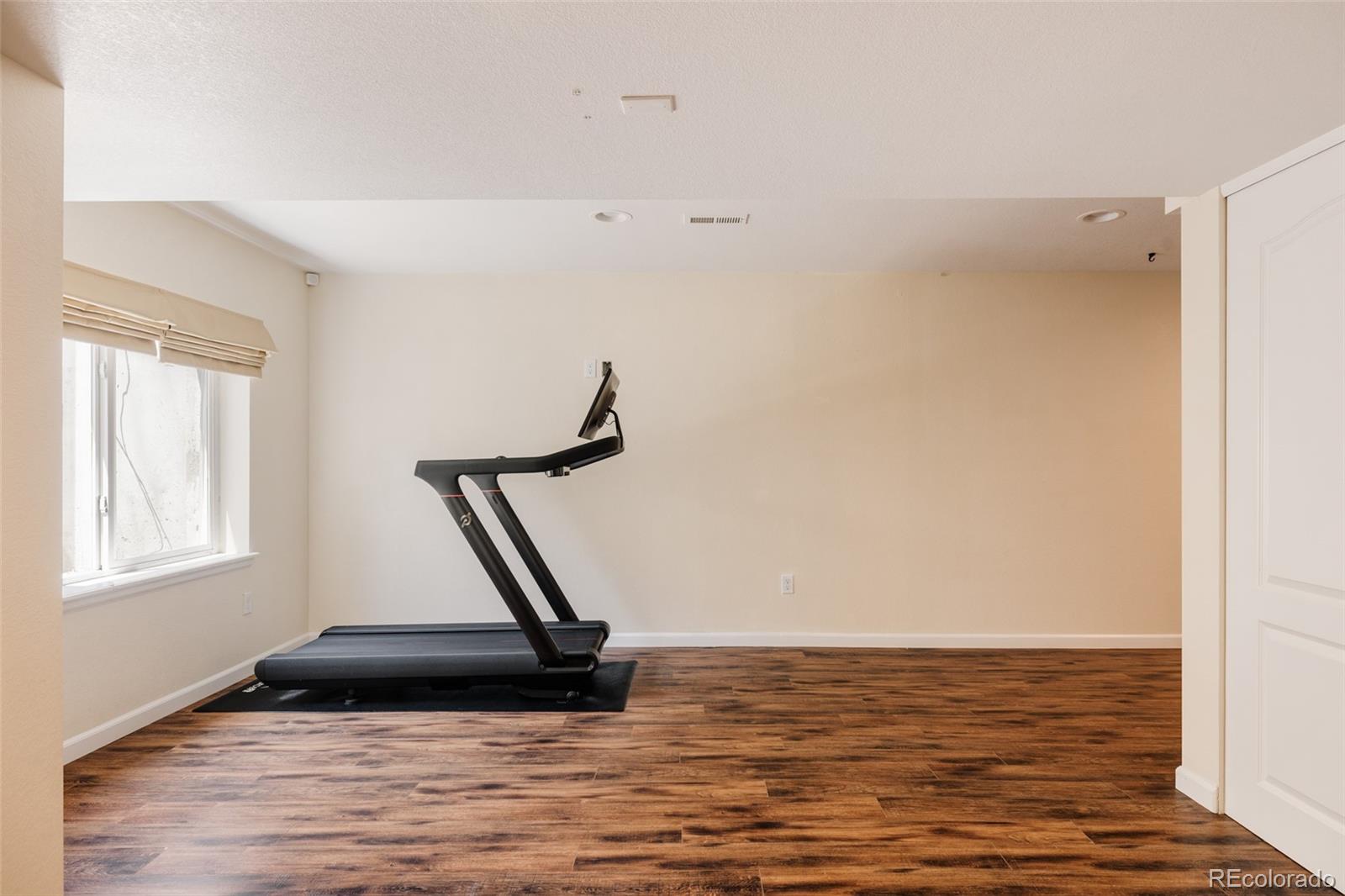 2899 Trinity Loop Broomfield, CO 80023 - Photo 25 of 33 a view of a room with wooden floor and windows