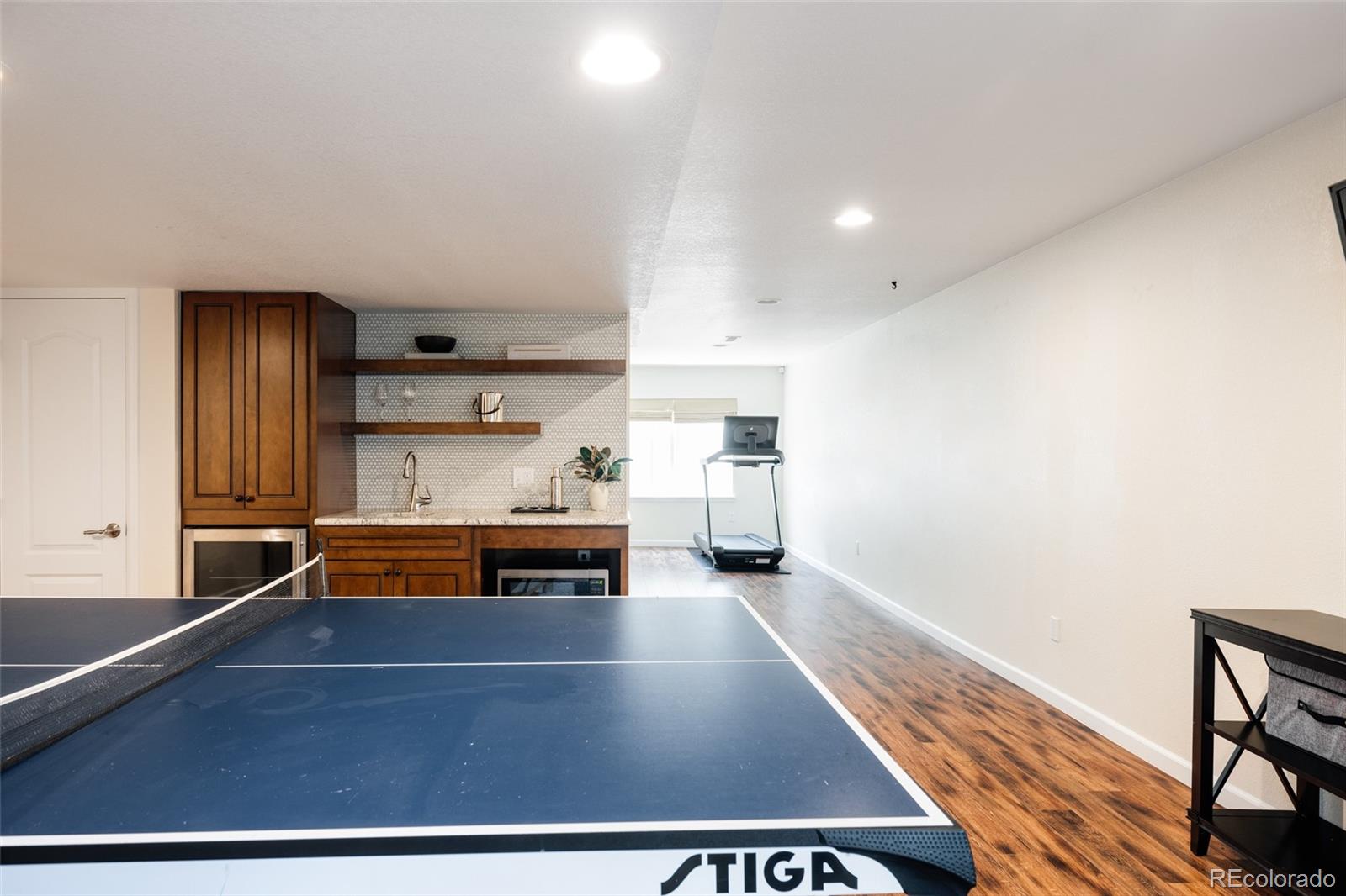 2899 Trinity Loop Broomfield, CO 80023 - Photo 27 of 33 a living room with furniture a table and kitchen view