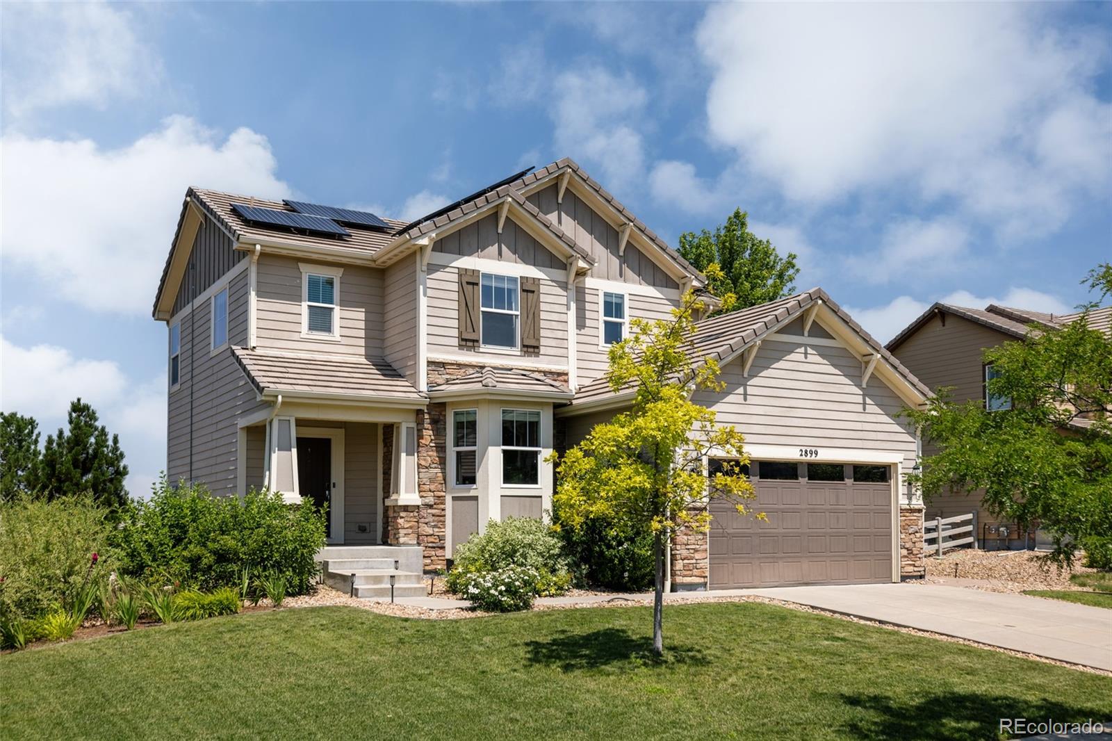 2899 Trinity Loop Broomfield, CO 80023 - Photo 29 of 33 a front view of a house with a yard and garage