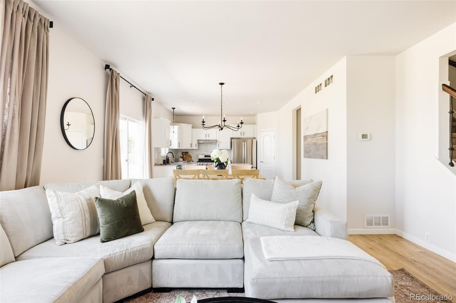 2899 Trinity Loop Broomfield, CO 80023 - Photo 5 of 33 a living room with furniture a clock and white walls
