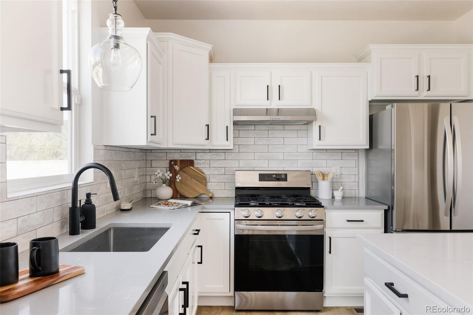 2899 Trinity Loop Broomfield, CO 80023 - Photo 8 of 33 a kitchen with a sink stove and refrigerator