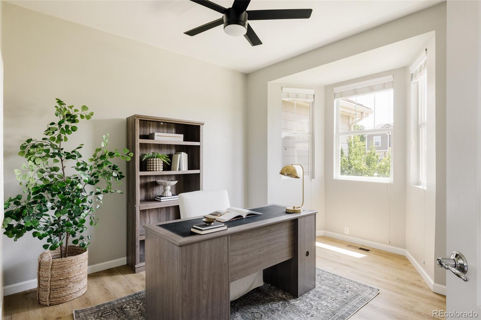 2899 Trinity Loop Broomfield, CO 80023 - Photo 10 of 33 a living room with a potted plant and a window