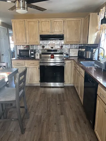 a kitchen with a stove a sink and a refrigerator