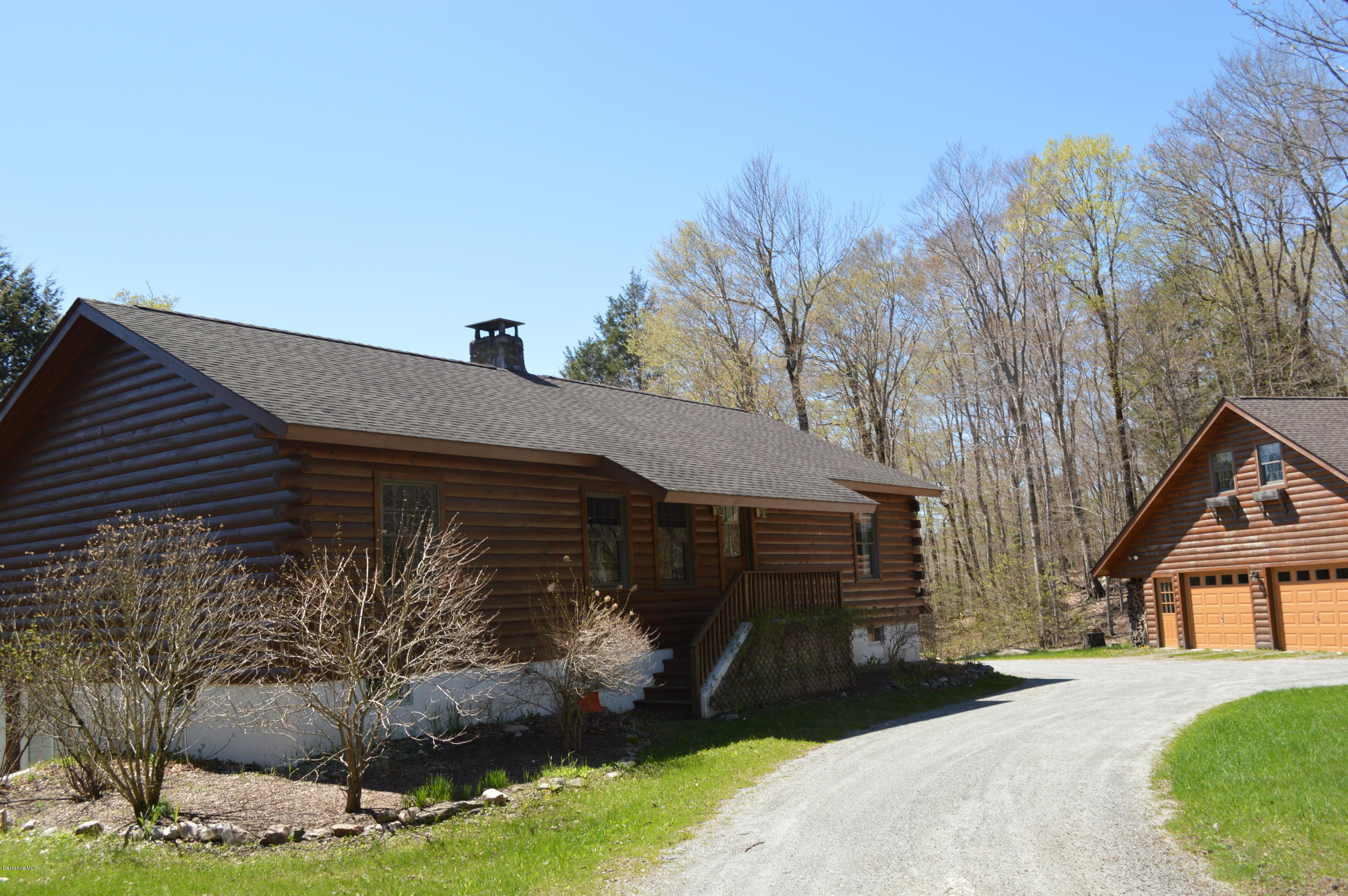 2034 West Center Road Otis, MA 01253 - Photo 1 of 50 a front view of a house with garden