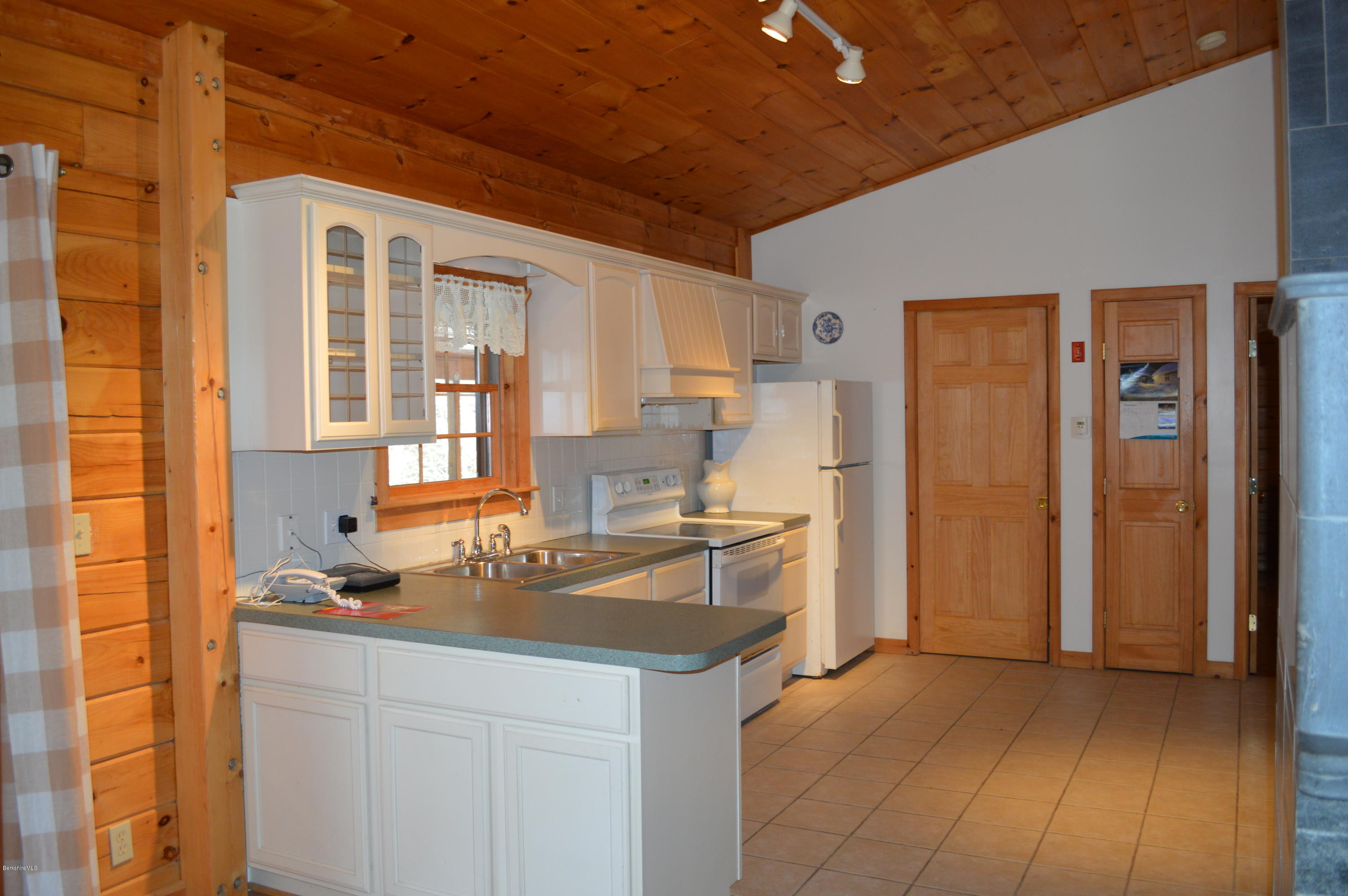 2034 West Center Road Otis, MA 01253 - Photo 12 of 50 a kitchen with a sink and refrigerator
