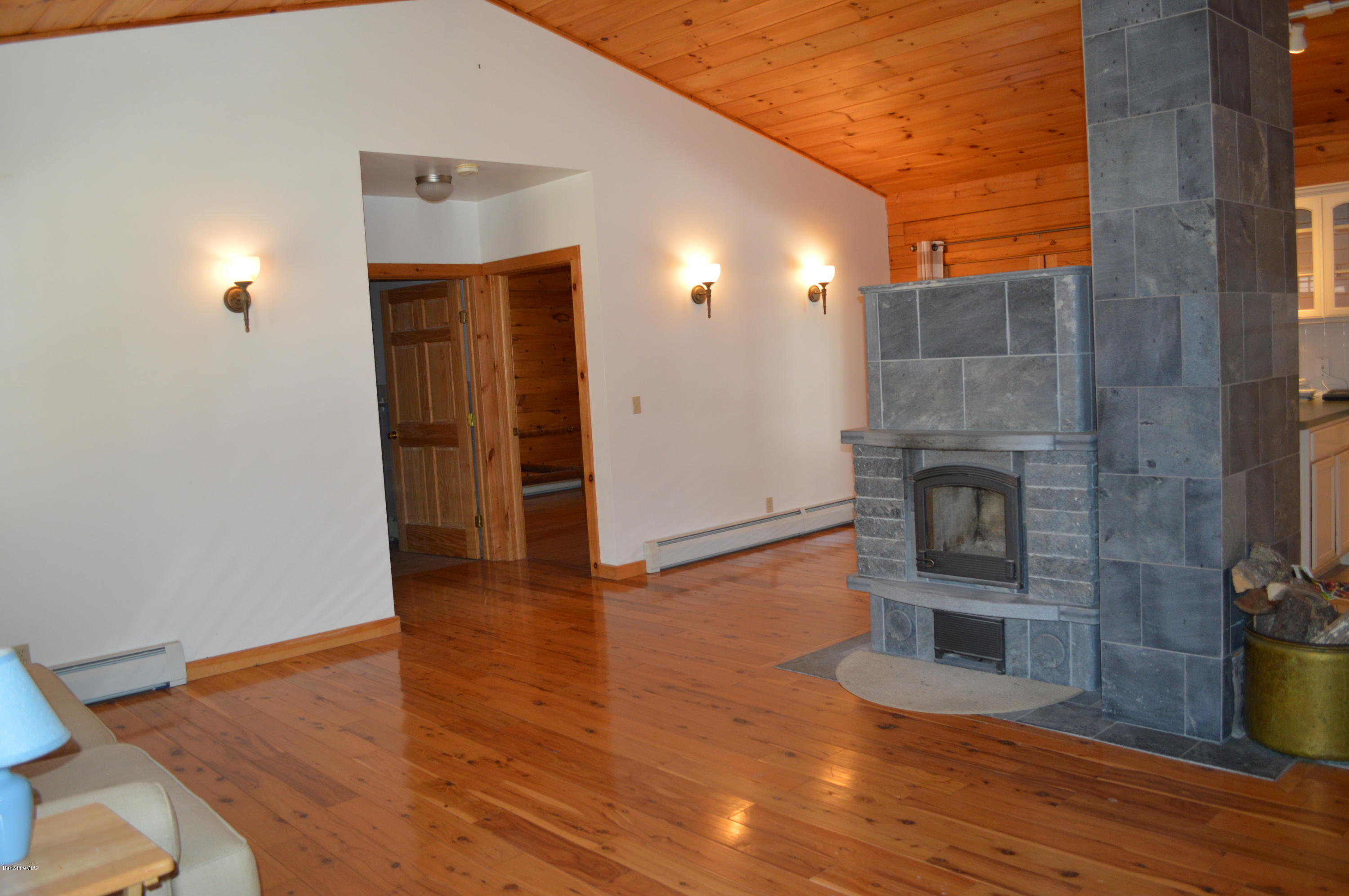 2034 West Center Road Otis, MA 01253 - Photo 15 of 50 a view of a livingroom with wooden floor and a fireplace