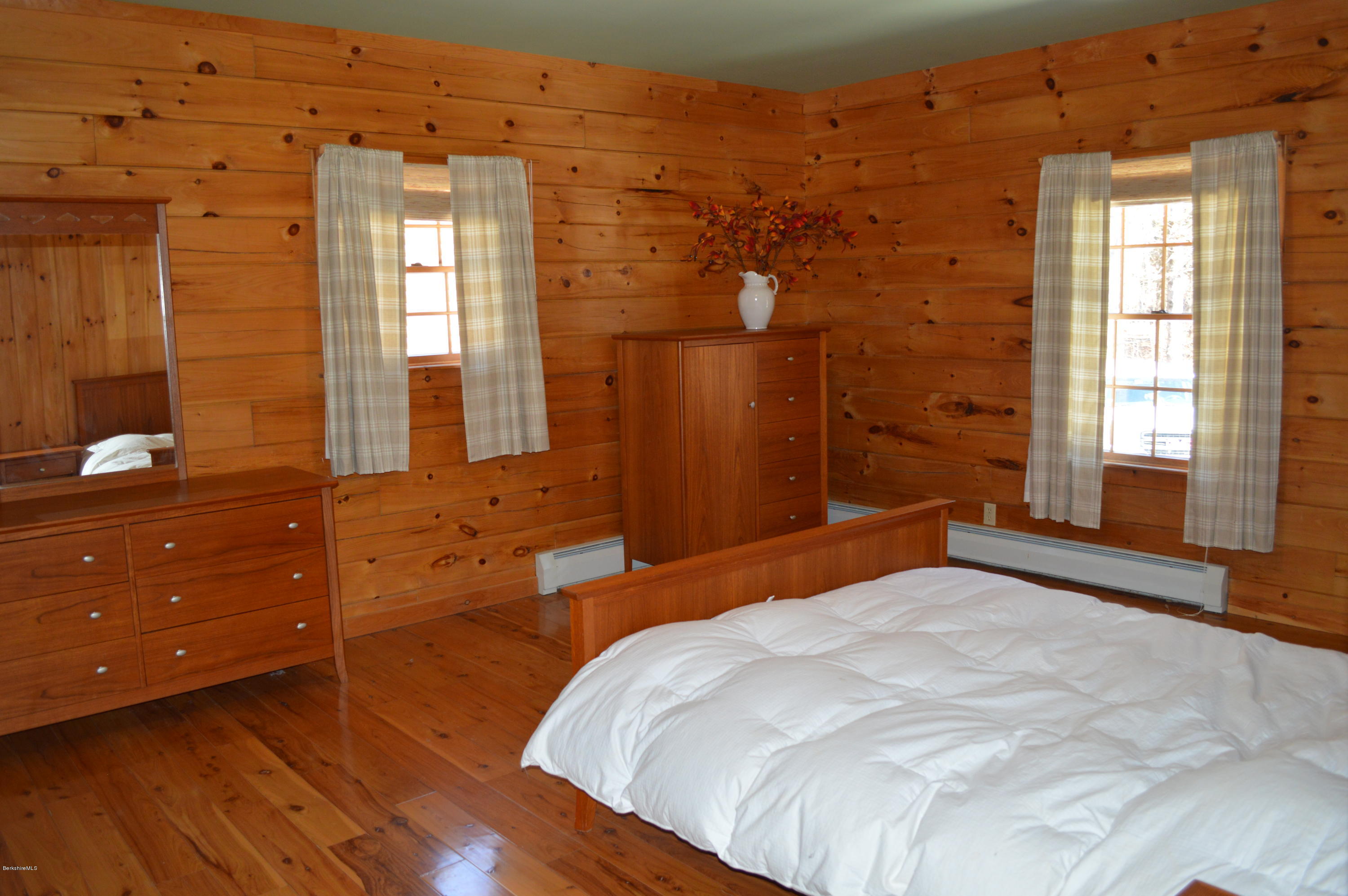 2034 West Center Road Otis, MA 01253 - Photo 18 of 50 a bedroom with a bed and a dresser