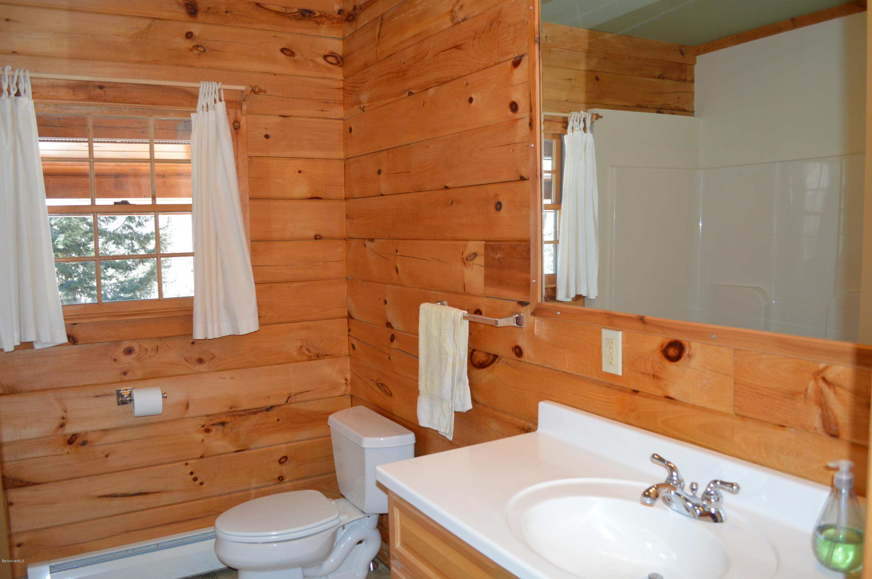 2034 West Center Road Otis, MA 01253 - Photo 19 of 50 a bathroom with a sink mirror vanity and toilet