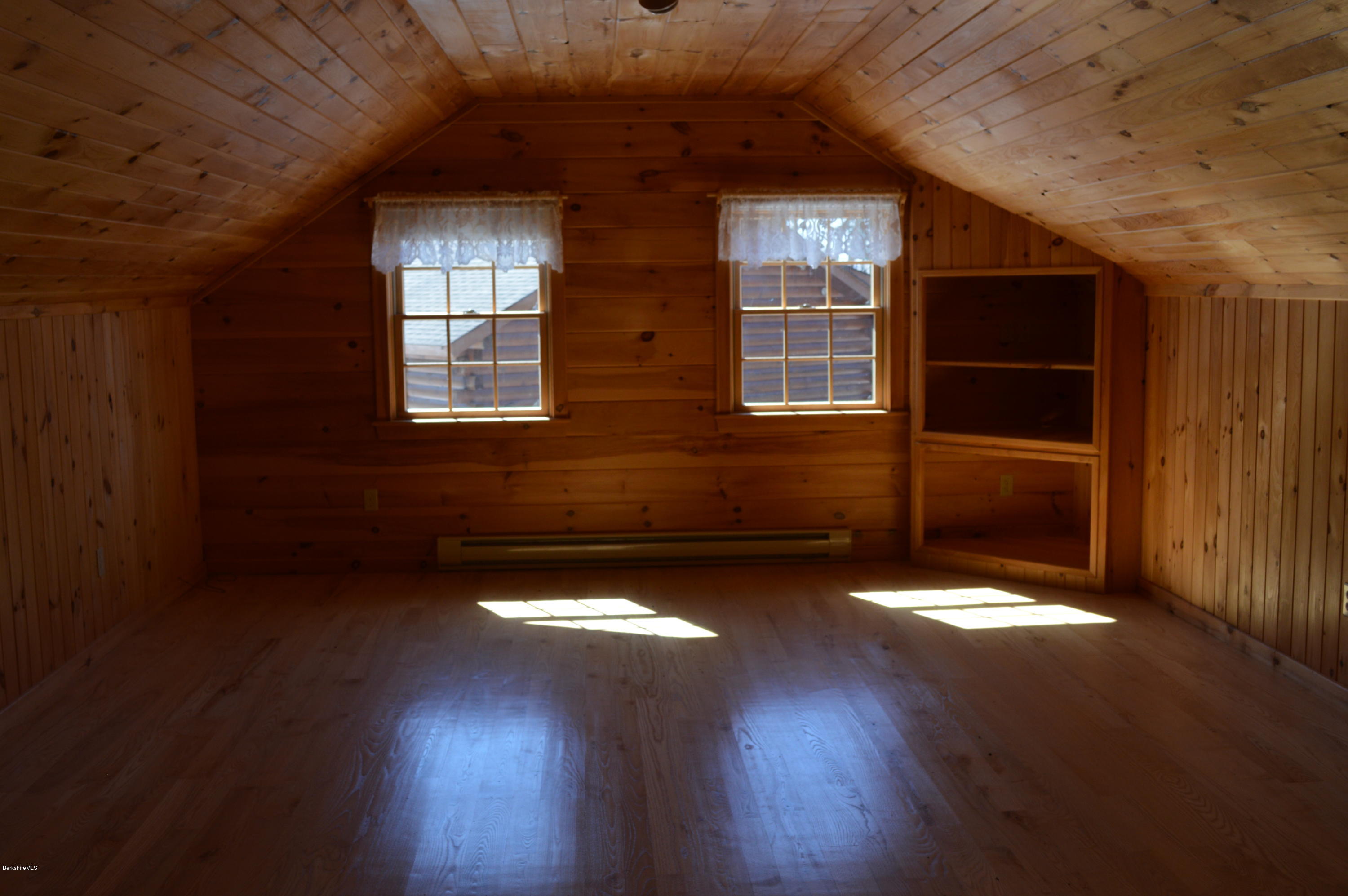 2034 West Center Road Otis, MA 01253 - Photo 30 of 50 a view of an empty room with wooden floor and a window