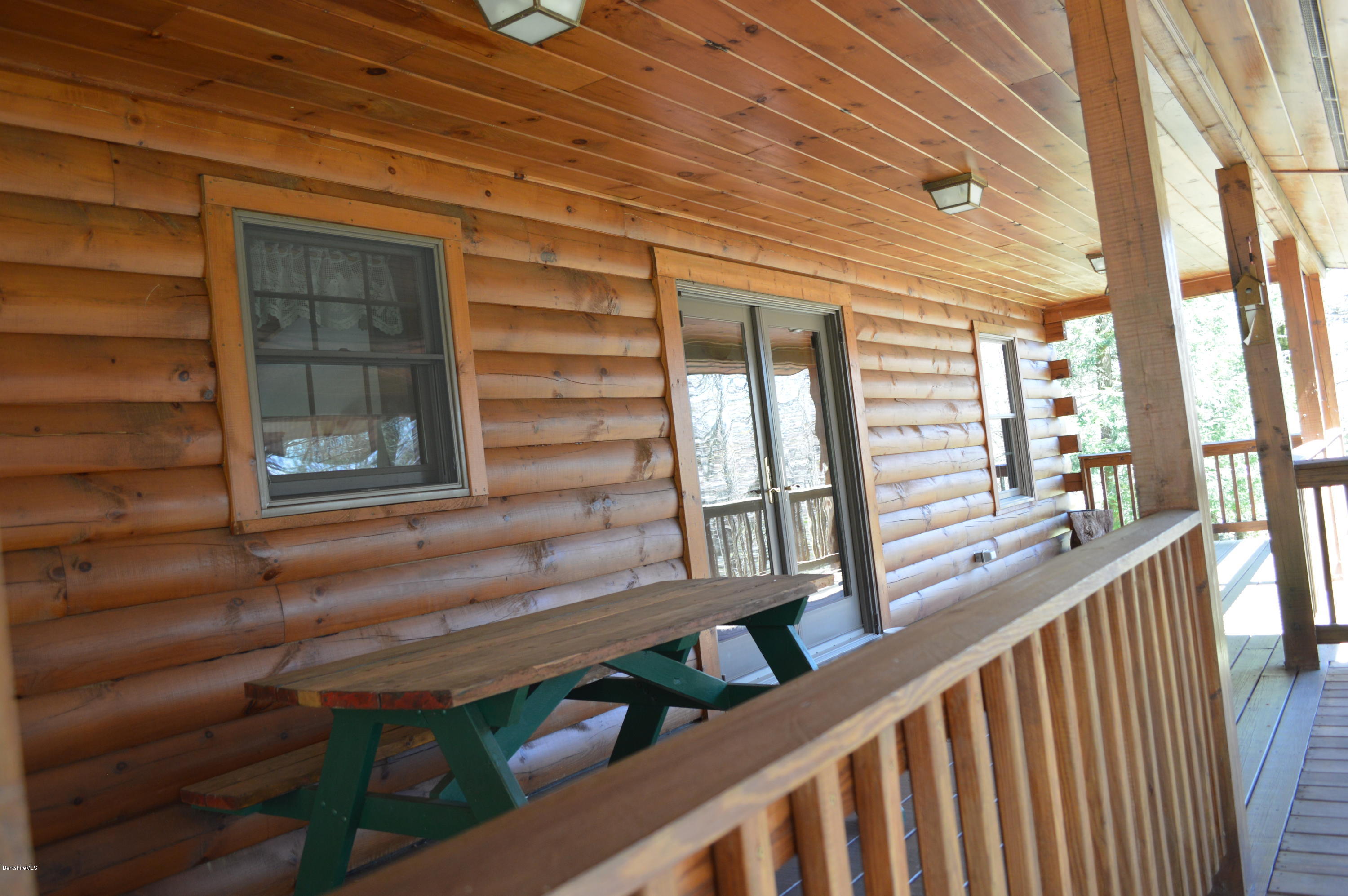 2034 West Center Road Otis, MA 01253 - Photo 4 of 50 a view of a porch with wooden stairs