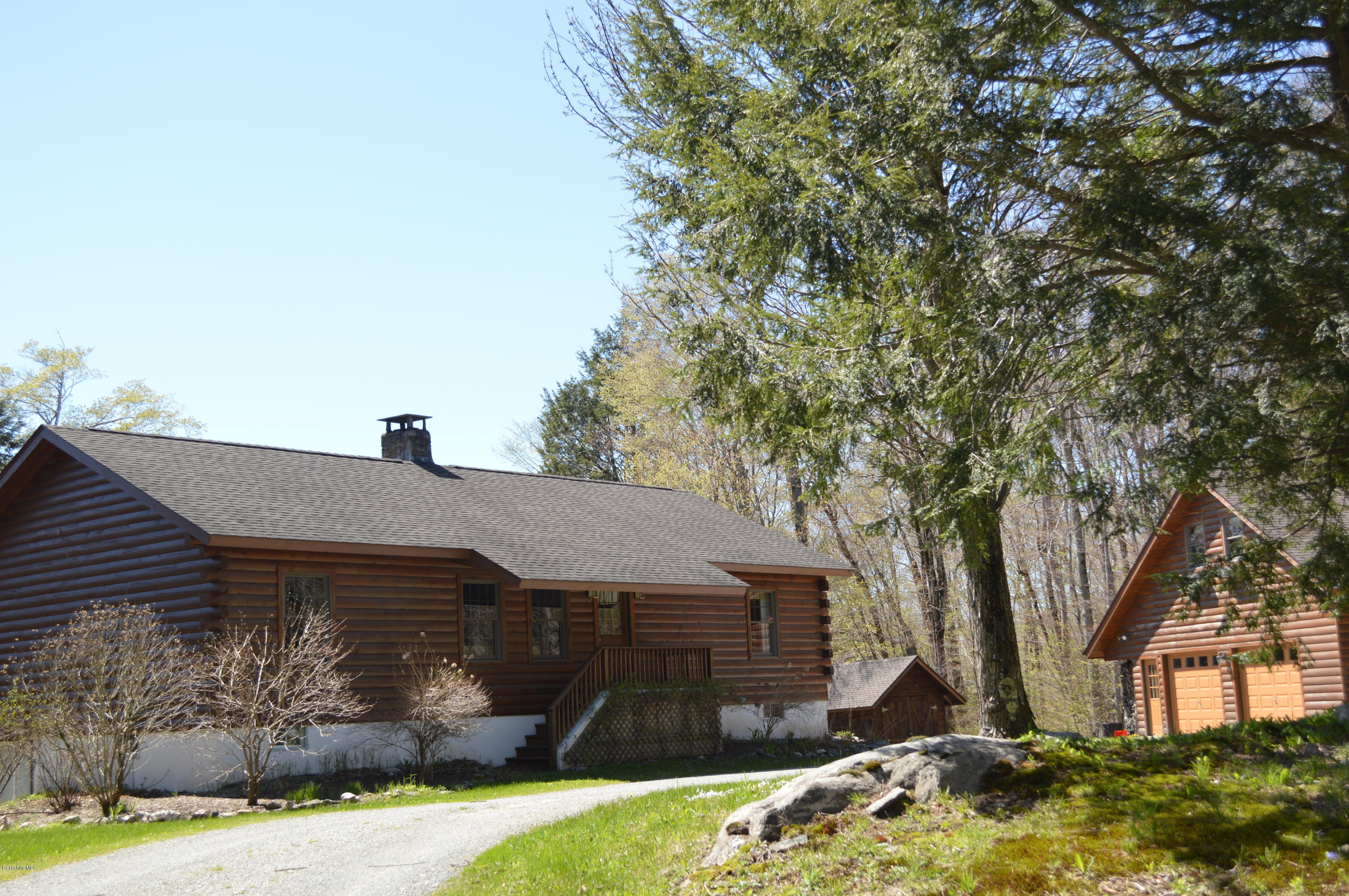 2034 West Center Road Otis, MA 01253 - Photo 44 of 50 a front view of a house with garden