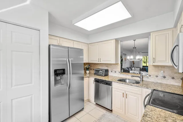 a kitchen with a sink stove and refrigerator
