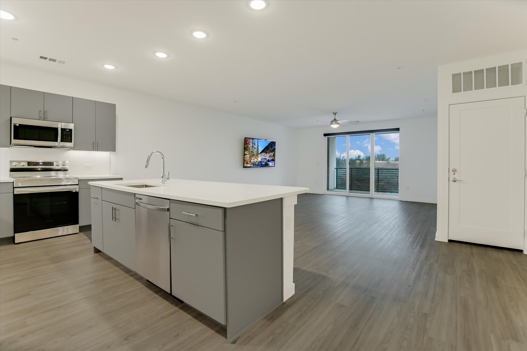 a kitchen with a sink cabinets and wooden floor