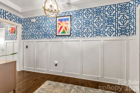 a kitchen with stainless steel appliances granite countertop a sink a stove and a wooden floor