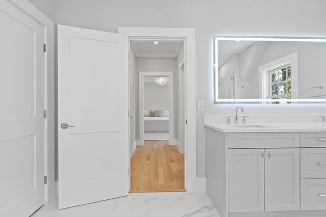 a en suite bathroom with a sink and a mirror