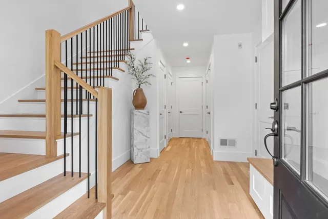a view of empty room with wooden floor