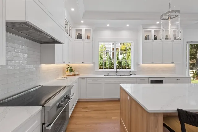 a kitchen with a sink stove and cabinets