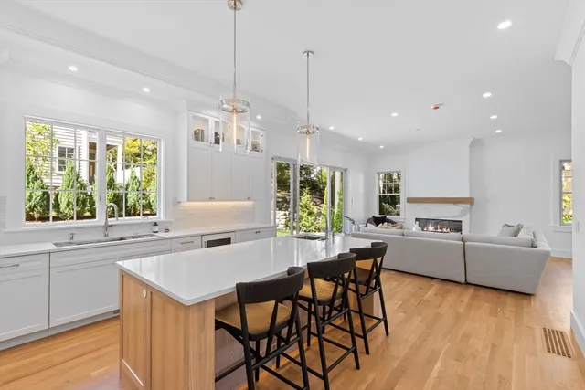 a kitchen with kitchen island a large counter top space appliances and a center island