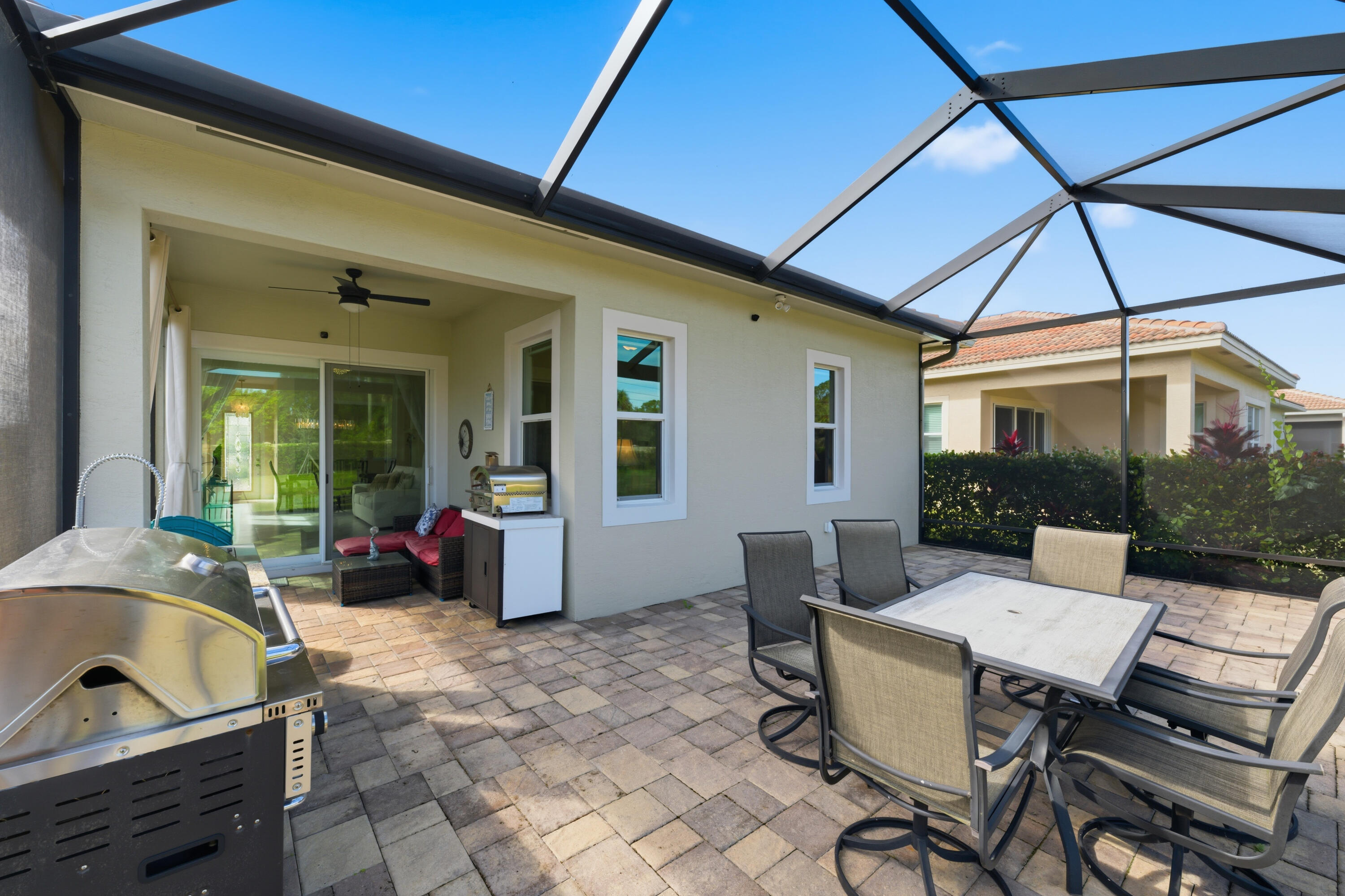 11473 Southwest Visconti Way Port St. Lucie, FL 34986 - Photo 1 of 69 a outdoor space with patio the couches and dinning table and chairs under an umbrella