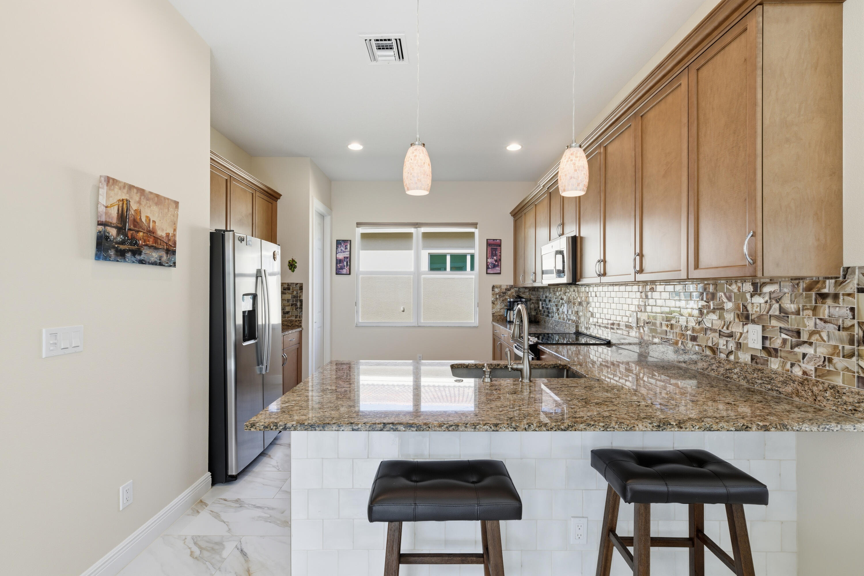 11473 Southwest Visconti Way Port St. Lucie, FL 34986 - Photo 11 of 69 a kitchen with stainless steel appliances granite countertop a refrigerator and a stove top oven