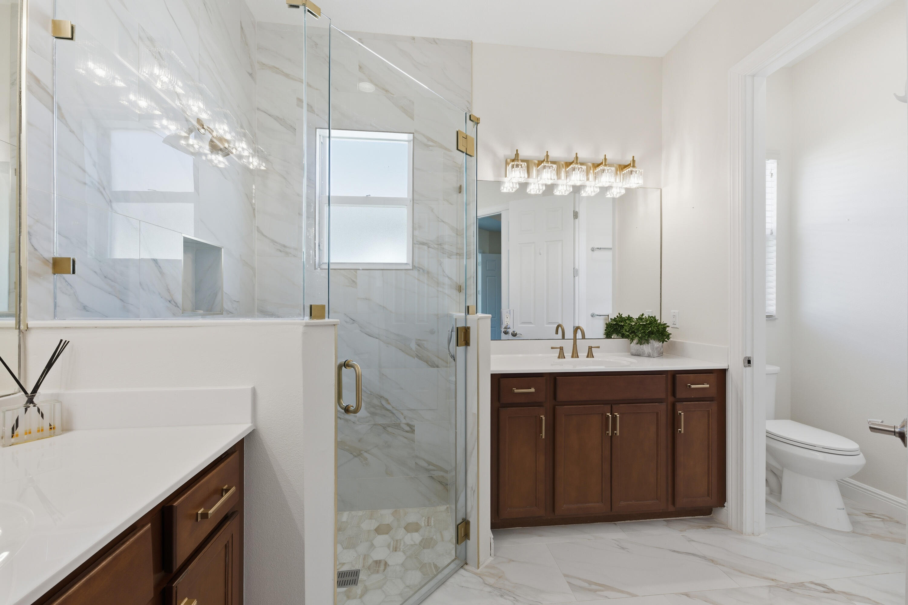 11473 Southwest Visconti Way Port St. Lucie, FL 34986 - Photo 18 of 69 a spacious bathroom with a granite countertop sink a toilet and a mirror