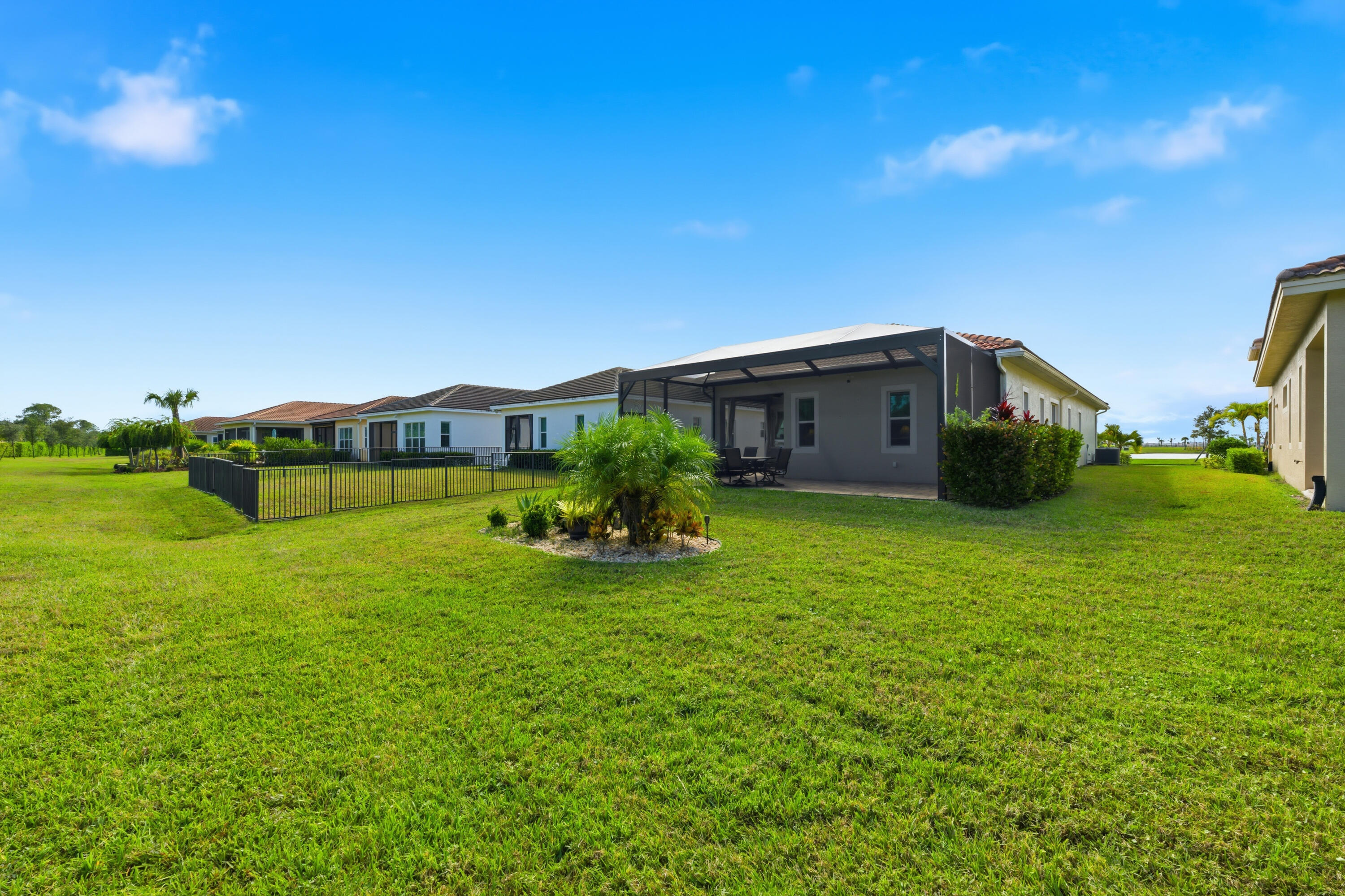 11473 Southwest Visconti Way Port St. Lucie, FL 34986 - Photo 27 of 69 a backyard of a house with plants and a garden